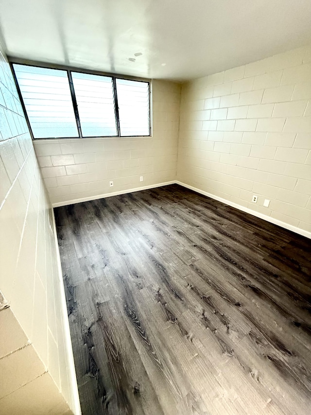 4156 Rice St Unit 306, Lihue, HI 96766 - empty room featuring wood finished floors, baseboards, and concrete block wall