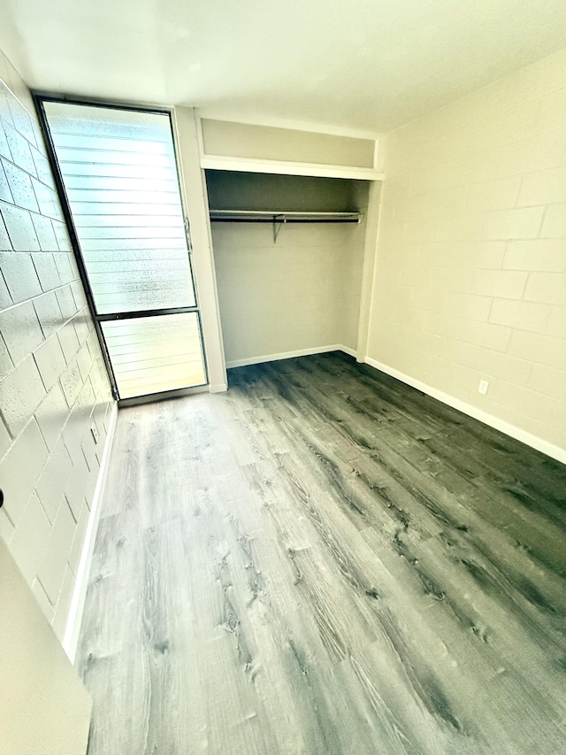 4156 Rice St Unit 306, Lihue, HI 96766 - unfurnished bedroom with wood finished floors, baseboards, and a closet
