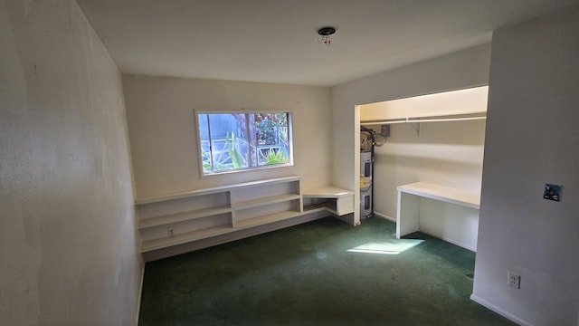 3215-C Wawae Rd, Kalaheo, HI 96741 - unfurnished bedroom with dark colored carpet, water heater, and a closet