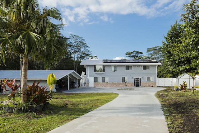15-1925 4th Ave, Keaau, HI 96749 - view of front facade with roof mounted solar panels and driveway