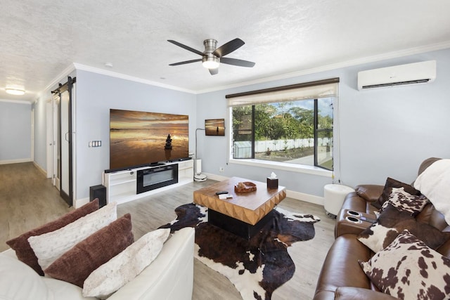 15-1925 4th Ave, Keaau, HI 96749 - living area with a wall mounted AC, a barn door, wood finished floors, a ceiling fan, and ornamental molding