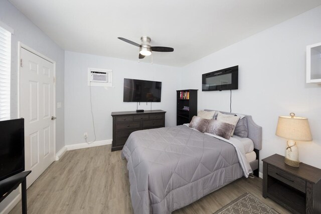 15-1925 4th Ave, Keaau, HI 96749 - bedroom featuring light wood-style flooring, a wall mounted air conditioner, and a ceiling fan
