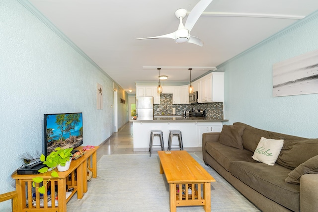 69-1647 Puako Beach Dr Unit 105, Kamuela, HI 96743 - living area featuring ceiling fan, crown molding, light wood-style flooring, and a textured wall