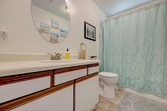16-2038 Maile Way, Pahoa, HI 96778 - bathroom with vanity, toilet, stone finish floors, and a shower with shower curtain
