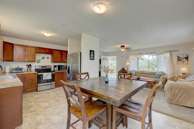 16-2038 Maile Way, Pahoa, HI 96778 - dining space with a textured ceiling, ceiling fan, and light flooring