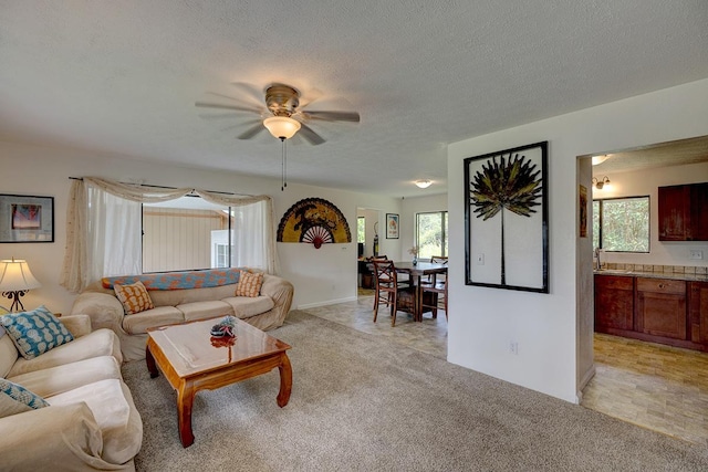 16-2038 Maile Way, Pahoa, HI 96778 - living area with ceiling fan, a textured ceiling, light carpet, and baseboards