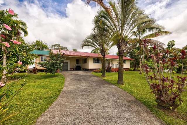 16-2038 Maile Way, Pahoa, HI 96778 - ranch-style home with asphalt driveway, metal roof, and a front lawn