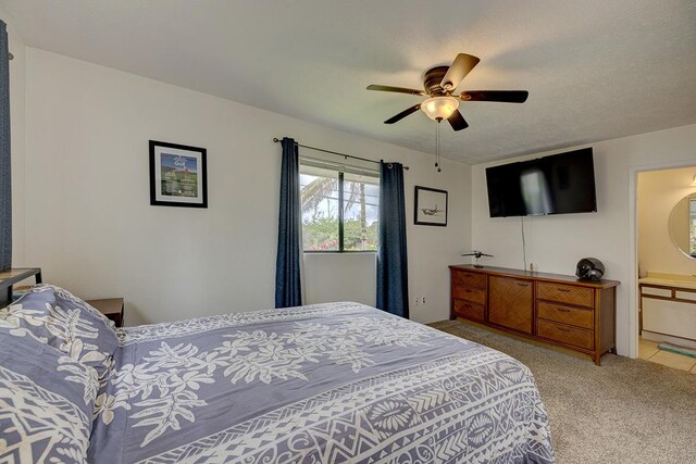 16-2038 Maile Way, Pahoa, HI 96778 - bedroom with light carpet, ceiling fan, and connected bathroom