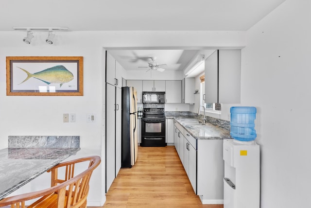 88-1506 Ewalu Ave, Captain Cook, HI 96704 - kitchen with black appliances, a sink, light wood-style flooring, ceiling fan, and rail lighting