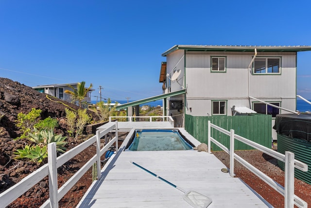 88-1506 Ewalu Ave, Captain Cook, HI 96704 - rear view of house with a wooden deck and metal roof