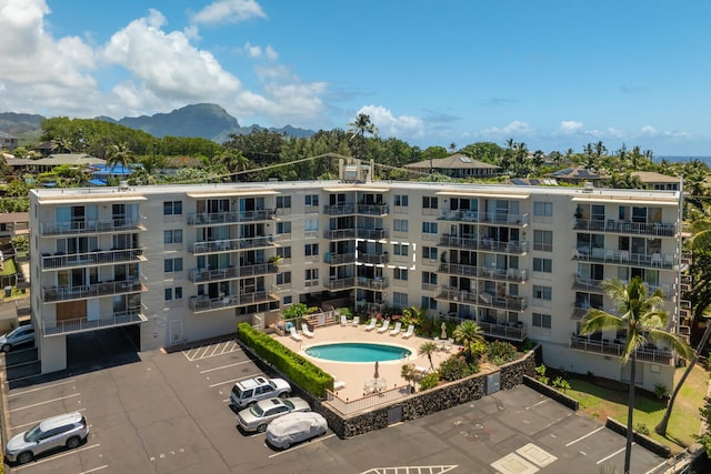 1763 Pee Rd Unit 304, Koloa, HI 96756 - view of apartment building / complex featuring a mountain view, uncovered parking, and a community pool