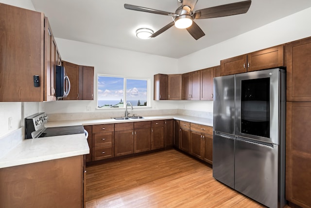 76-6347 Kupuna St, Kailua-Kona, HI 96740 - kitchen with appliances with stainless steel finishes, a sink, ceiling fan, light wood-style floors, and light countertops