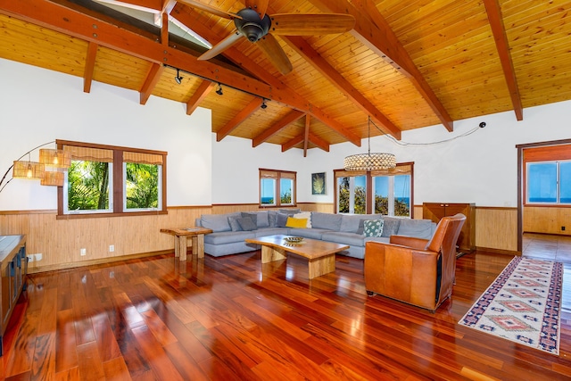 76-6319 Leone St, Kailua-Kona, HI 96740 - living area with a wainscoted wall, wood ceiling with exposed beams, hardwood / wood-style floors, wood walls, and ceiling fan