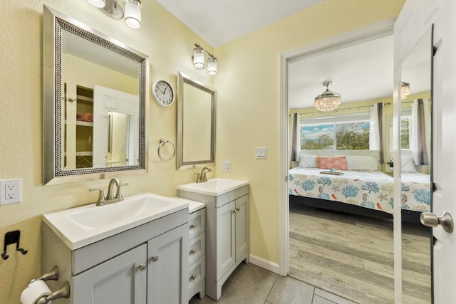 15-1653 28th Ave, Keaau, HI 96749 - full bathroom with ensuite bathroom, two vanities, tile patterned flooring, a textured wall, and baseboards