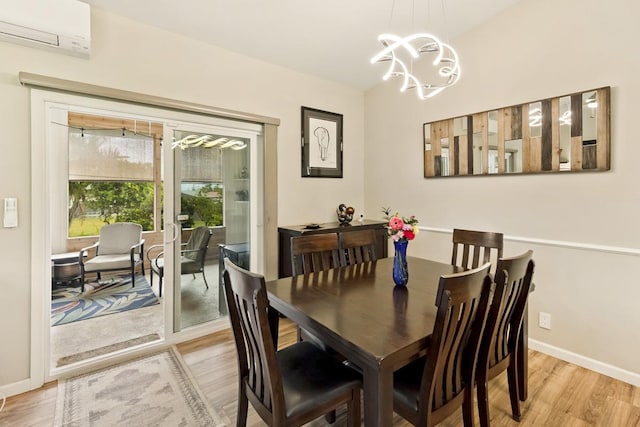 16-2081 Ohia Dr, Pahoa, HI 96778 - dining space with a wall unit AC, light wood-style flooring, and a chandelier