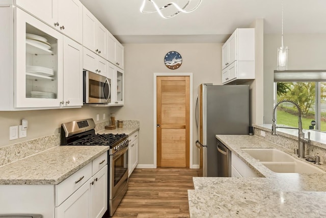 16-2081 Ohia Dr, Pahoa, HI 96778 - kitchen featuring stainless steel appliances, wood finished floors, glass insert cabinets, and white cabinets