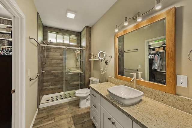 16-2081 Ohia Dr, Pahoa, HI 96778 - full bathroom featuring a walk in closet, vanity, a stall shower, and wood finished floors