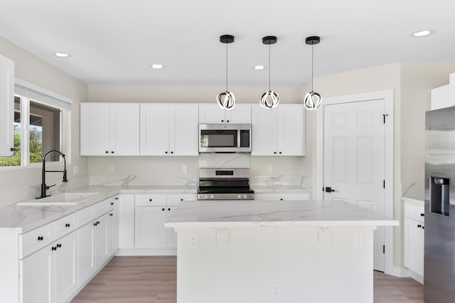 16-2147 Stardust Dr, Pahoa, HI 96778 - kitchen with appliances with stainless steel finishes, a sink, light stone counters, light wood-style flooring, and recessed lighting