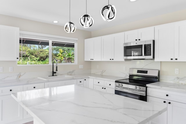 16-2147 Stardust Dr, Pahoa, HI 96778 - kitchen with stainless steel appliances, a sink, a kitchen island, and light stone countertops