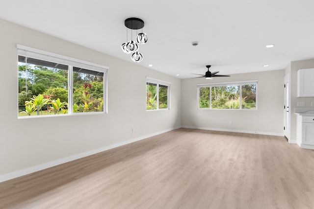 16-2147 Stardust Dr, Pahoa, HI 96778 - unfurnished living room with healthy amount of natural light, baseboards, light wood-style floors, and recessed lighting