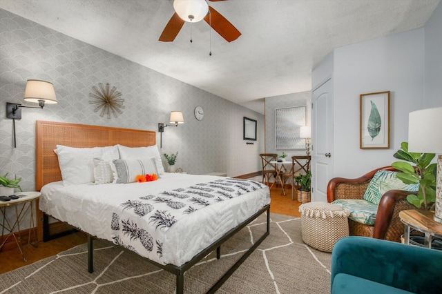 75-5776 Kuakini Hwy Unit 123, Kailua-Kona, HI 96740 - bedroom featuring wallpapered walls, a ceiling fan, and baseboards