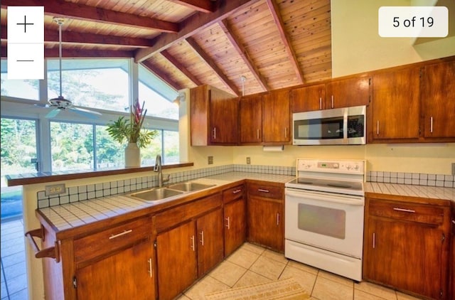 15-473 Anae St, Pahoa, HI 96778 - kitchen with stainless steel microwave, white electric range oven, a sink, wood ceiling, and tile counters