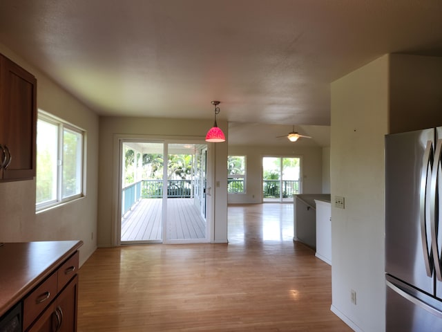 15-974 Lemiwai Rd, Keaau, HI 96749 - kitchen with freestanding refrigerator, light wood-type flooring, open floor plan, pendant lighting, and a ceiling fan