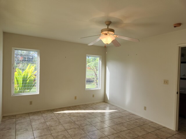15-974 Lemiwai Rd, Keaau, HI 96749 - tiled spare room featuring plenty of natural light, ceiling fan, a smoke detector, and baseboards