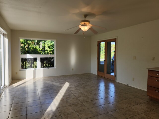 15-974 Lemiwai Rd, Keaau, HI 96749 - spare room with plenty of natural light, ceiling fan, and dark tile patterned flooring