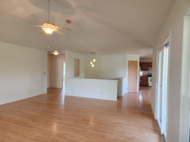 15-974 Lemiwai Rd, Keaau, HI 96749 - unfurnished living room with light wood-style flooring, ceiling fan, vaulted ceiling, and baseboards