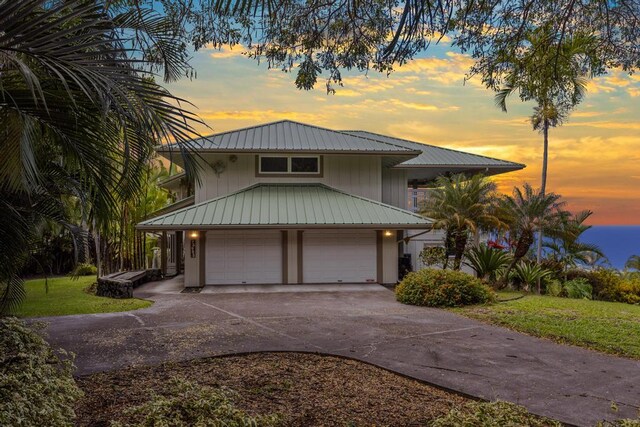 76-985 Aeo St, Kailua-Kona, HI 96740 - view of front facade featuring driveway, metal roof, a garage, and a lawn