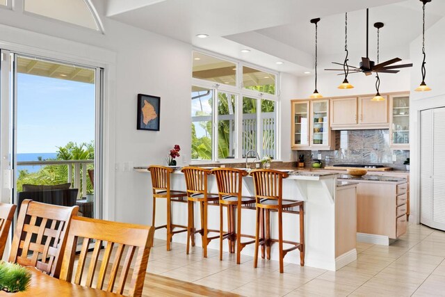 76-985 Aeo St, Kailua-Kona, HI 96740 - kitchen featuring backsplash, plenty of natural light, a kitchen breakfast bar, a peninsula, and recessed lighting