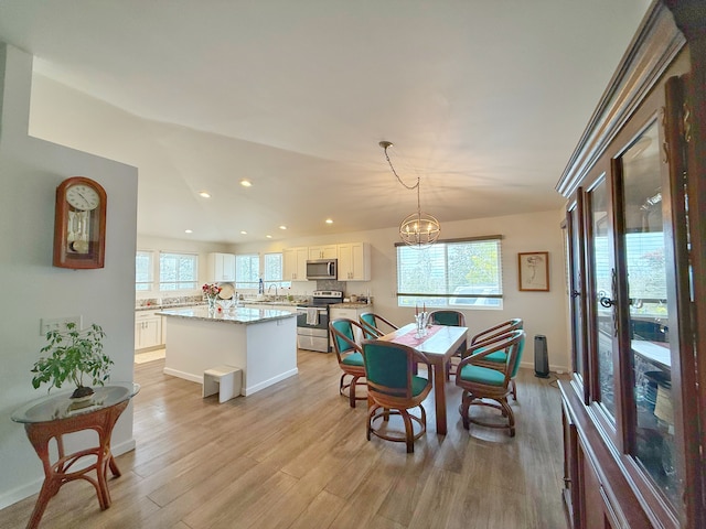 92-8858 Paradise Pkwy, Ocean View, HI 96737 - dining space featuring recessed lighting, light wood-style floors, a chandelier, and baseboards