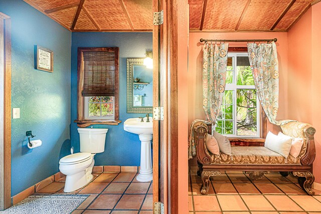 15-869 Lemiwai Rd, Keaau, HI 96749 - half bath with toilet, tile patterned flooring, a textured wall, wood ceiling, and baseboards