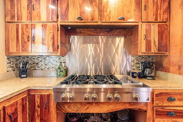 15-869 Lemiwai Rd, Keaau, HI 96749 - kitchen featuring stainless steel gas cooktop, decorative backsplash, and brown cabinets