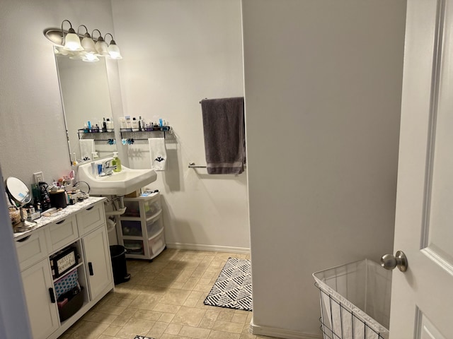 73-1111 Nuuanu Pl Unit N103, Kailua-Kona, HI 96740 - bathroom featuring a sink and stone finish floors