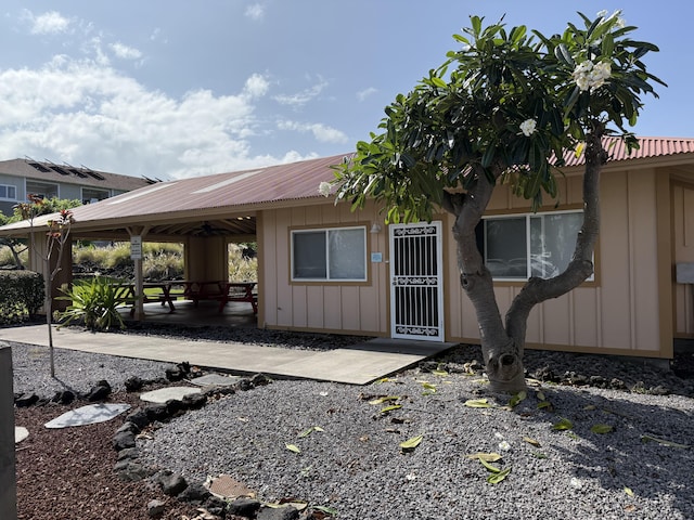 73-1111 Nuuanu Pl Unit N103, Kailua-Kona, HI 96740 - view of front facade featuring board and batten siding and a patio
