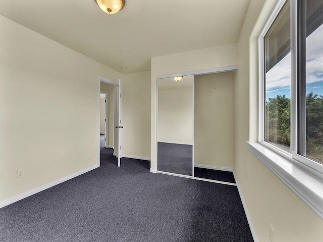 94-1727 Kaulua St, Naalehu, HI 96772 - spare room featuring baseboards and dark carpet