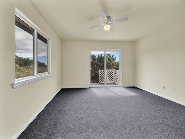 94-1727 Kaulua St, Naalehu, HI 96772 - unfurnished room featuring dark carpet, baseboards, and a ceiling fan