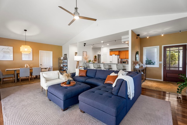 76-6398 Pualani St Unit 7, Kailua-Kona, HI 96740 - living area with light wood-style floors, ceiling fan, high vaulted ceiling, rail lighting, and baseboards
