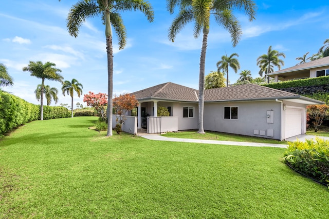 76-6398 Pualani St Unit 7, Kailua-Kona, HI 96740 - back of house with stucco siding, a garage, and a lawn
