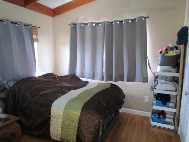 89-902 Rd Rd, Captain Cook, HI 96704 - bedroom with wood finished floors, beamed ceiling, and baseboards