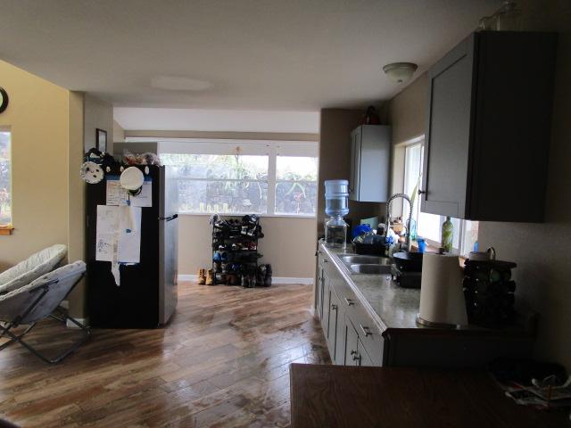 89-902 Rd Rd, Captain Cook, HI 96704 - kitchen featuring freestanding refrigerator, a sink, wood finished floors, and light countertops