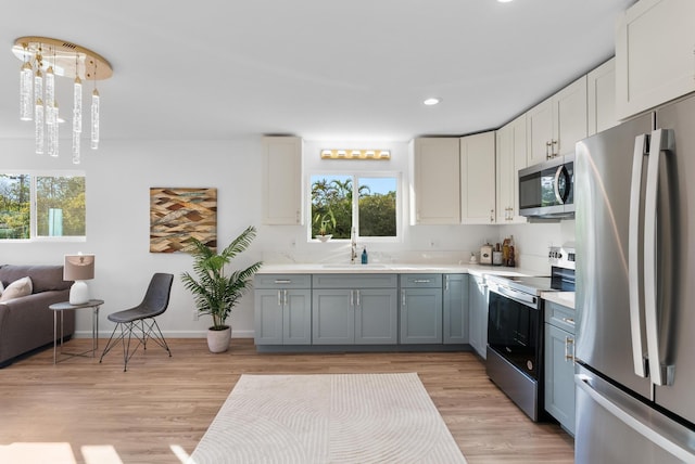 16-2143 Uilani Dr, Pahoa, HI 96778 - kitchen featuring stainless steel appliances, light countertops, healthy amount of natural light, light wood-style floors, and recessed lighting