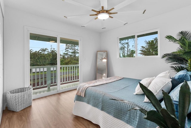 16-2143 Uilani Dr, Pahoa, HI 96778 - bedroom featuring access to outside, multiple windows, wood finished floors, and a ceiling fan