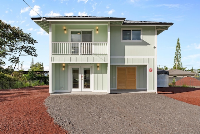 16-2143 Uilani Dr, Pahoa, HI 96778 - view of front of home featuring french doors, board and batten siding, a balcony, and metal roof