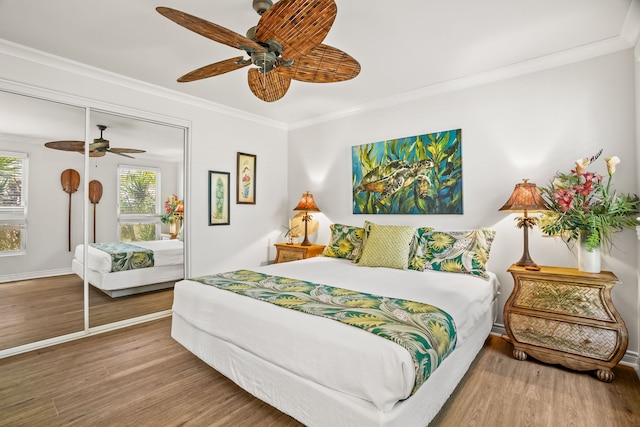 4055 Aloalii Dr, Princeville, HI 96722 - bedroom with wood finished floors, a closet, ornamental molding, a ceiling fan, and baseboards