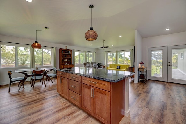 16-1516 Pohaku Cir, Keaau, HI 96749 - kitchen with brown cabinetry, a kitchen island, light wood-style flooring, pendant lighting, and recessed lighting