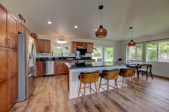 16-1516 Pohaku Cir, Keaau, HI 96749 - kitchen featuring stainless steel appliances, brown cabinets, plenty of natural light, a breakfast bar area, and recessed lighting