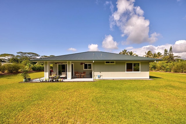 16-1516 Pohaku Cir, Keaau, HI 96749 - rear view of house featuring a patio area, a lawn, and metal roof